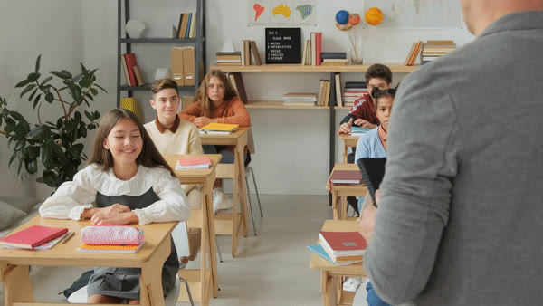 Pupils at their desks in a bright classroom